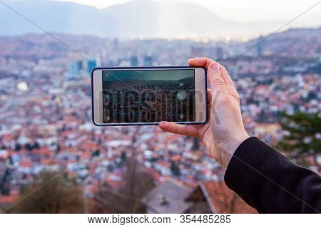 Person Photographing Cityscape Of Sarajevo With Mobile Phone