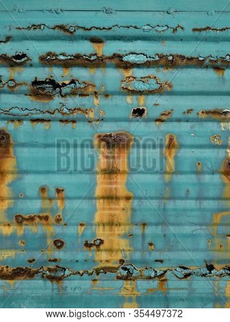 Strong Metal Corrosion. A Rotten Garage Door In Turquoise. Blue Painted Corrugated Fence. Remedies F