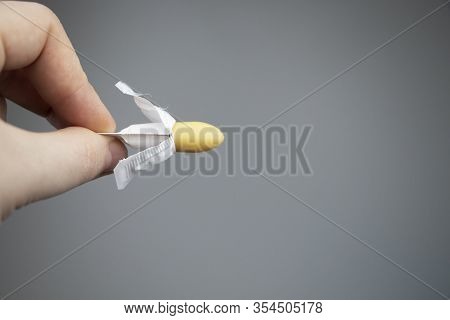 Vaginal Or Rectal Candle In Hands On A Light Background. The Drug Is In The Form Of Suppositories. T