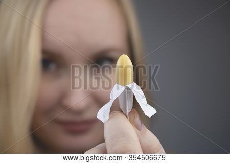 Vaginal Or Rectal Suppository In The Hands Of A Woman. The Drug Is In The Form Of Suppositories. The