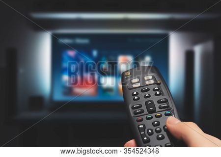 Vod Service On Television. Man Watching Tv, Streaming Service, Video On Demand, Remote Control In Ha