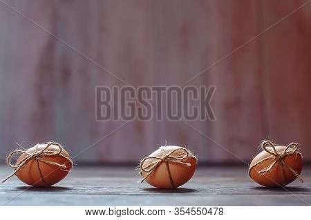 Easter Beige Eggs Decorate With Rope On Brown Wooden Background
