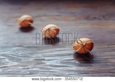 Easter Beige Eggs Decorate With Rope On Brown Wooden Background