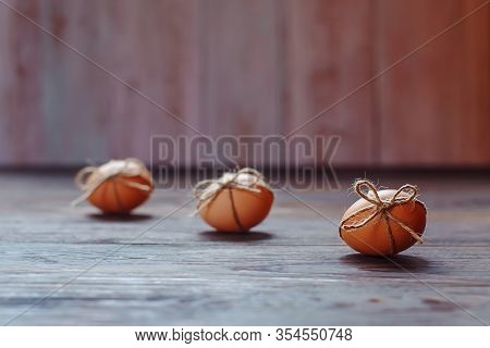 Easter Beige Eggs Decorate With Rope On Brown Wooden Background