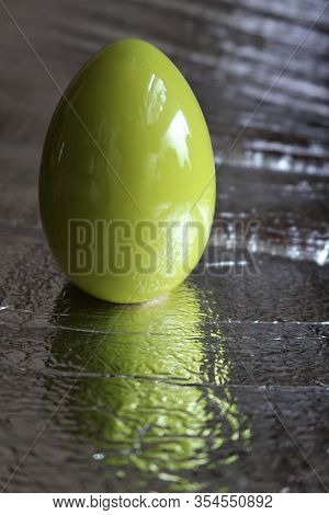 A Green Easter Egg On Silver Background