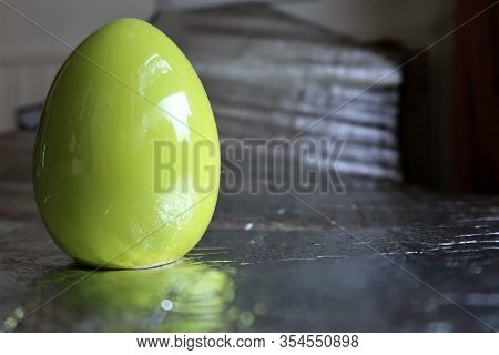 A Green Easter Egg On Silver Background