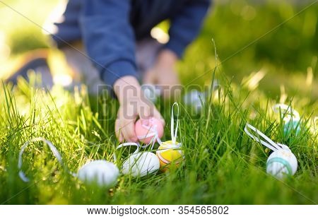 Little Boy Hunting For Egg In Spring Garden On Easter Day. Traditional Easter Festival Outdoors. Foc