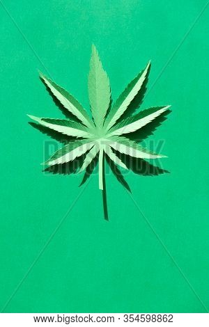 Cannabis Leaf Made Of Paper On Green Background