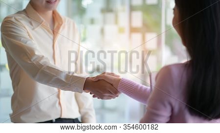 The New Employees Shakehands To Work Together In The Modern Office.