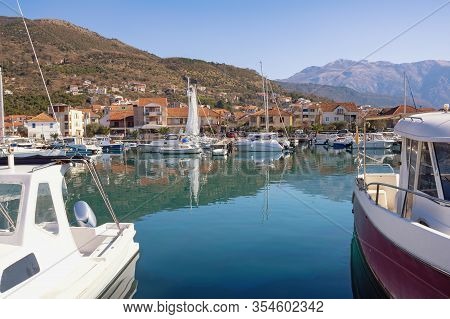 Fishing Boats In Harbor. Montenegro, Bay Of Kotor. View Of Marina Kalimanj In Tivat City Against Lov