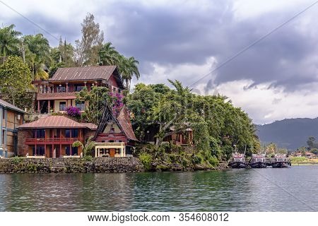 Parapat, Indonesia - January 1, 2020. Guest Houses In The Form Of A Traditional Indonesian Dwelling 