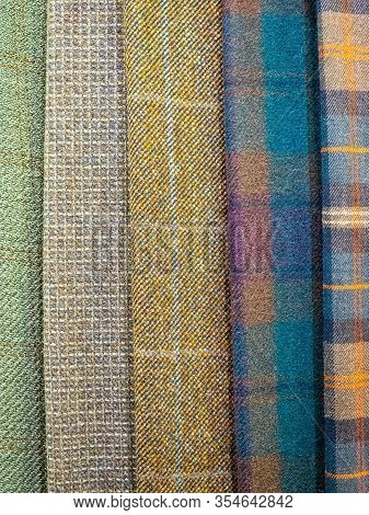 Original And Fashionable Plaid Fabrics Close-up. Large Assortment Of Fabrics In The Store. A Tailor 