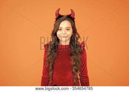Little Devil. Little Girl Red Horns Celebrate Halloween. Carnival Concept. Small Child With Imp Styl