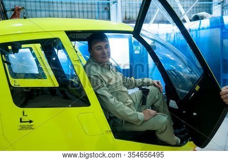 Tyumen, Russia - June 19, 2019: Aircraft Repair Helicopter Utair Engineering Plant. Pilot In Robinso
