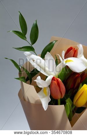 Detail Closeup Fresh Spring Bouquet Of Tulip, Iris, Ruscus On A Gray Background, Selective Focus