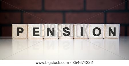 Pension Text On Wooden Blocks. Reduction Of Pensions And Payments. Low Pensions Leading To Poverty.