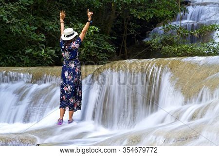 Traveler Stand Enjoy In Waterfall  At Erawan Waterfall And  Natural In Kanchanaburi Province Thailan