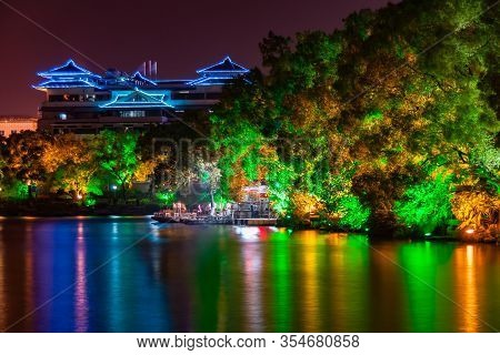 Guilin, China - May 9, 2010: Riyue Shuangta Cultural Park. Colorful Lights On Structures And Shoreli