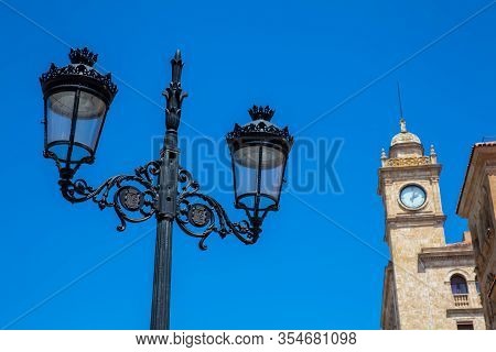 Beautiful Street Lamp And The Clock Tower Of An Antique Building At Zamora Street In Salamanca City