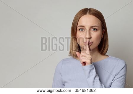 Shhh! European Mysterious Woman With Short Hair Keep Index Finger Over Lips Gesturing Silence, Isola