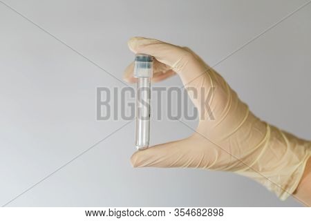 Empty Test Tube For Biomaterial Analysis In The Hands Of A Nurse. Clinical Virus Analysis With Preca