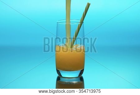 Fresh Orange Juice Pouring Into A Glass
