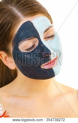 Girl With Black White Mud Mask On Face