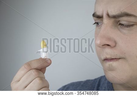 A Man Holds A Rectal Candle In His Hand. A Drug That Is Inserted Into The Rectum. Rectal Suppository