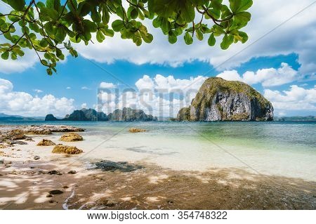 El Nido, Palawan, Philippines. Leaves Framed Picture Of Pinagbuyutan Island And Beautiful Tropical C