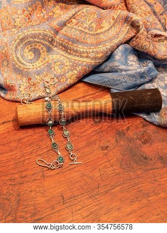 Green Onyx Bead Bracelet In Silver, With Indian Skarf And Wooden Striker On Wooden Table Background