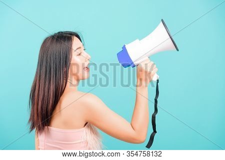Smiling Face Portrait Asian Beautiful Woman Her Usring Megaphone On Blue Background, With Copy Space