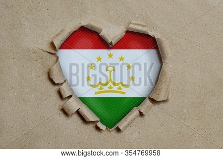 3d Illustration. Heart Shaped Hole Torn Through Paper, Showing Tadjik Flag