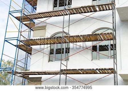 Extensive Scaffolding For Building A New House. Constraction Of Platforms For Building Works