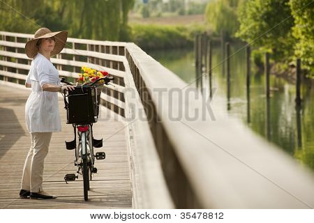 Woman with bike by river