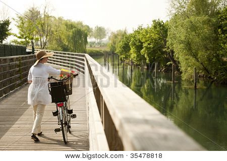 Woman with bike by river