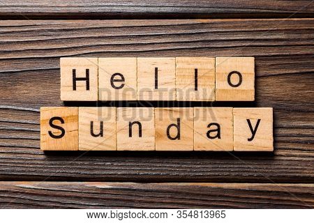 Hello Sunday Word Written On Wood Block. Hello Sunday Text On Wooden Table For Your Desing, Concept