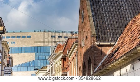 Groningen, Netherlands - March 07, 2020: Old Houses In Front Of The Modern Building Of The Forum In 