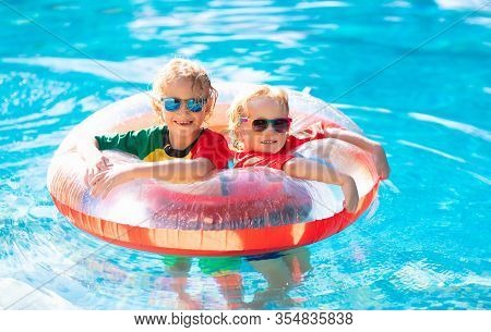 Kids In Swimming Pool. Life Jacket For Child.