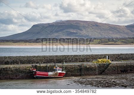 Mullaghmore Harbour Wall And Moored Fishing Boat In Ireland