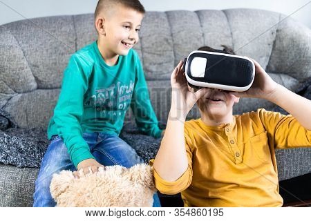 Cute, Little Boy Having Fun With Vr Headset With His Brother Next To Him And Teddy Bear Toy. Kids An