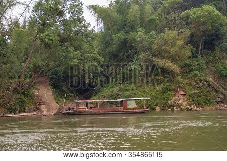 Guilin, China - May 10, 2010: Along Li River. Ramshackled And Rusty Ferry Anchored Near Shoreline Co