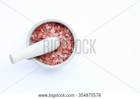 Pink Himalayan Salt In Mortar With Pestle On With Background. Copy Space