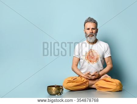 Yogi Man, Hare Krishna Follower, Dressed In Traditional Orange And White Dhoti Clothes, Holding Rosa