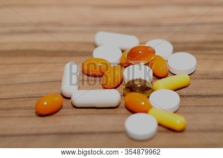 Pills Background.many Colorful Pills On A Brown Wooden Background. Cropped Shot, Horizontal, Side Vi
