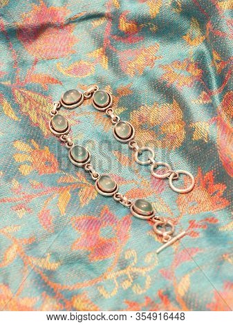 Green Onyx Bead Bracelet In Silver, Isolated On Indian Skarf Background