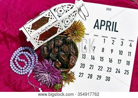 April Monthly Calendar On The Red Silk Textile Background. Islamic Ramadan Eid Festive Background Wi