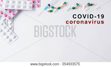 Coronavirus Phrase Text On A White Background With Medicines And A Syringe. 2019-ncov. Wuhan, China 