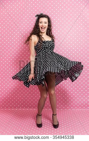 Inspiring Sexy Girl In Pin-up Style Is Turning Around, Smiling. Her Dress Is Raising Up, Baring Her 