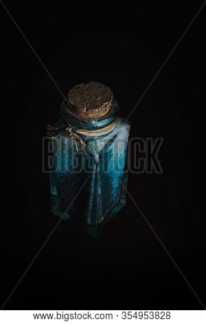 Fancy Bottle With Blue Bath Salts For Relaxing Spa Treatments With Wooden Background