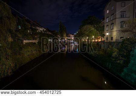 Panorama Of Ljubljanica River In The City Center Of Ljubljana With A Bridge In Background In Summer,